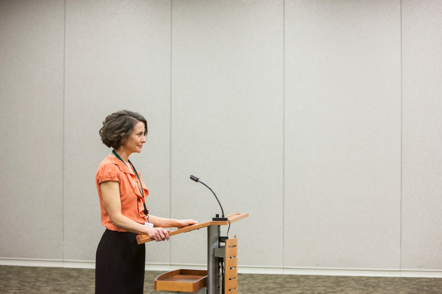 Businesswoman speaking from a podium to an audience in a conference-how-to-not-be-nervous-for-a-presentation